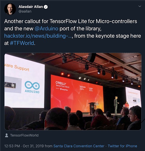 Alasdair Allan on Twitter, photo of Man and woman on stage in front of conference crowd, with Arduino and O'Reilly TensorFlow slides on rear screens.