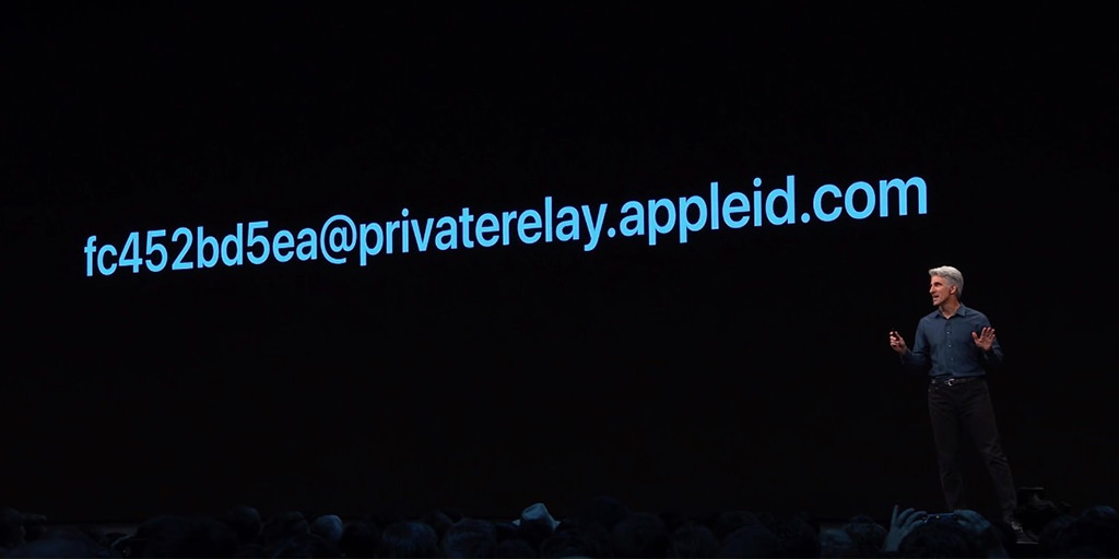 Speaker on stage introduces Apple Sign In Code Example in Conference Presentation